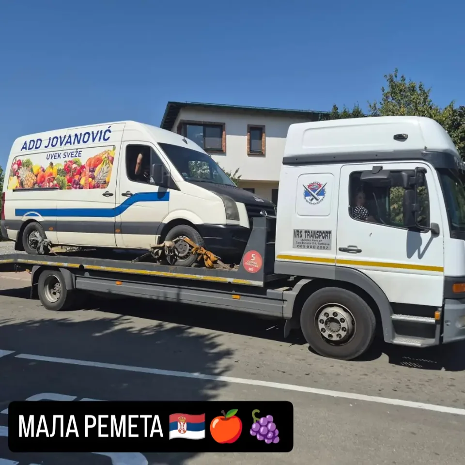 Beli dostavni kombi na platformi kamiona.